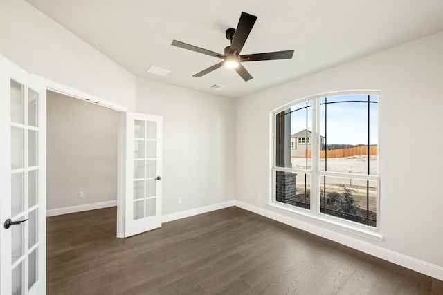 empty room with dark wood-type flooring, ceiling fan, and french doors