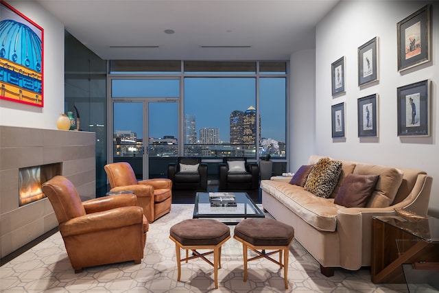 living room with a tile fireplace and expansive windows