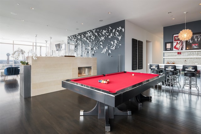 game room featuring a wall of windows, dark hardwood / wood-style floors, and pool table