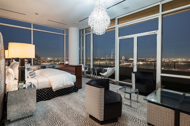 bedroom with a wall of windows, carpet, and an inviting chandelier