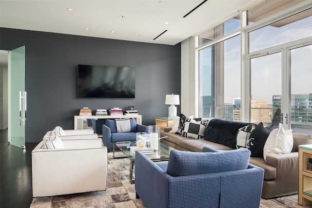 living room with a healthy amount of sunlight and floor to ceiling windows