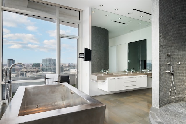 bathroom with wood-type flooring, a wall of windows, vanity, and plus walk in shower