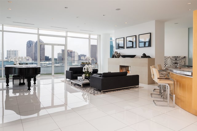 tiled living room featuring a wall of windows