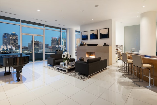 tiled living room featuring a wall of windows