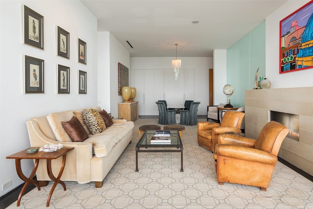 living room featuring a tiled fireplace