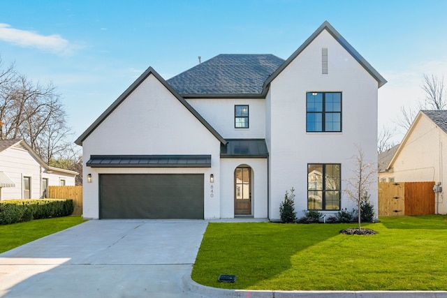 modern farmhouse style home featuring a standing seam roof, fence, concrete driveway, and brick siding