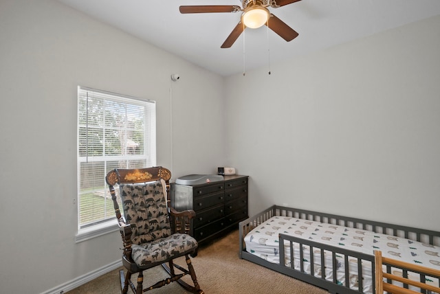 carpeted bedroom with ceiling fan and multiple windows