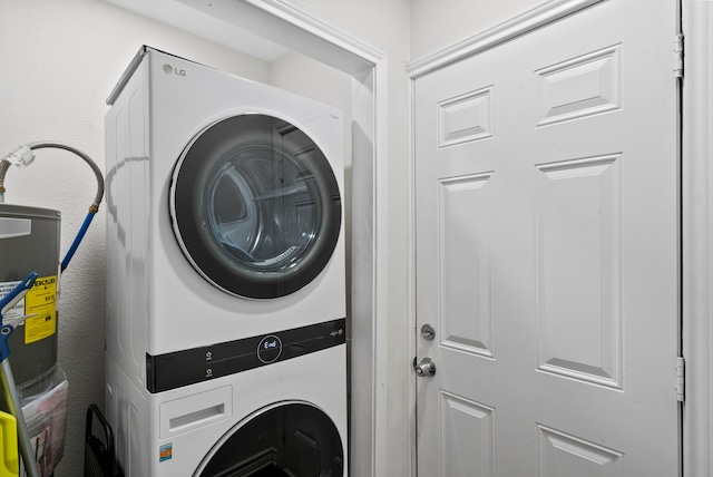 clothes washing area featuring stacked washer / drying machine