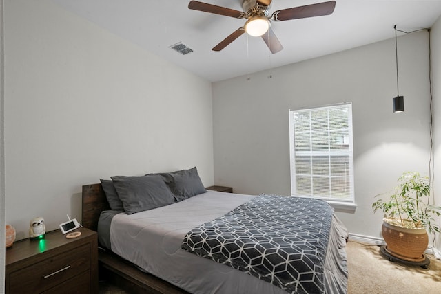 carpeted bedroom featuring ceiling fan and multiple windows