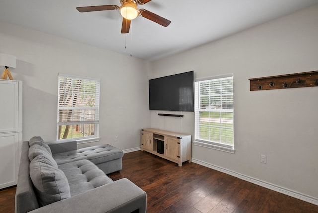 living room with ceiling fan and dark hardwood / wood-style flooring