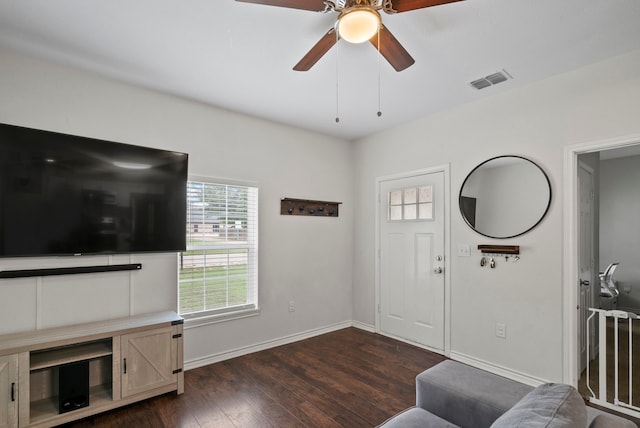 interior space featuring dark wood-type flooring and ceiling fan