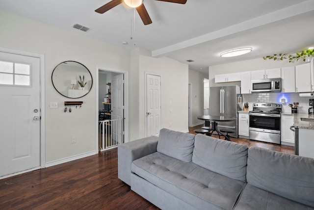 living room featuring ceiling fan and dark hardwood / wood-style flooring