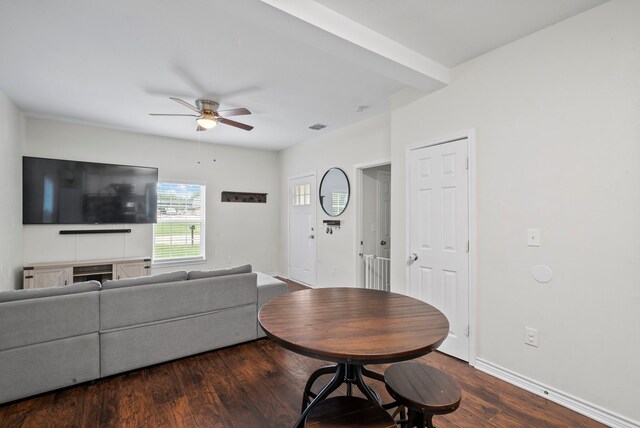 living room featuring dark wood-type flooring and ceiling fan