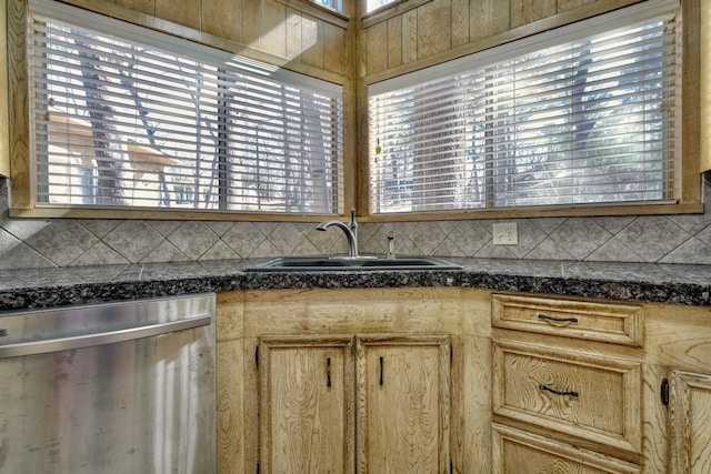 kitchen with light brown cabinetry, dishwasher, sink, and decorative backsplash