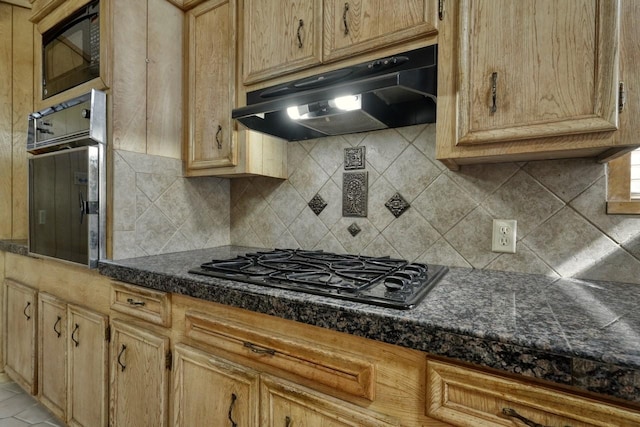 kitchen featuring tasteful backsplash, ventilation hood, and black appliances