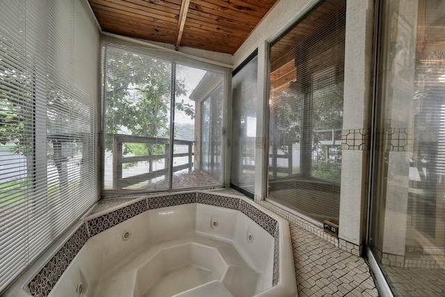 bathroom featuring wood ceiling and a bathtub