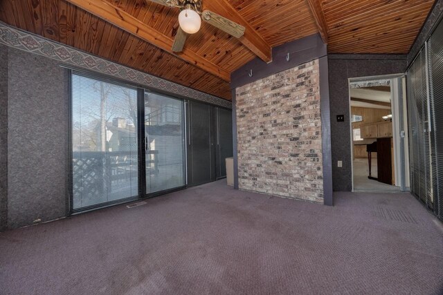 spare room featuring carpet, vaulted ceiling with beams, wooden ceiling, and ceiling fan