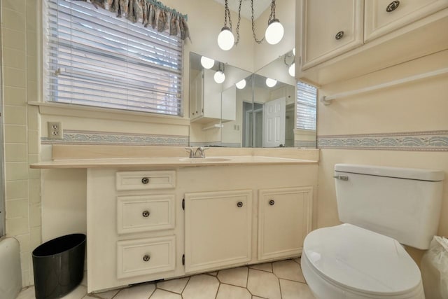 bathroom with vanity, tile patterned flooring, and toilet