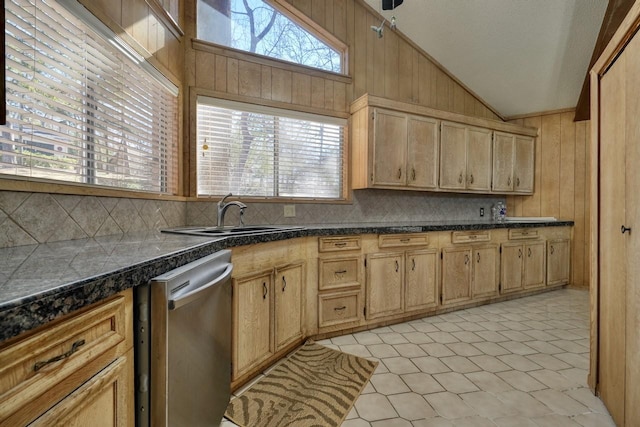 kitchen featuring lofted ceiling, sink, backsplash, and dishwasher