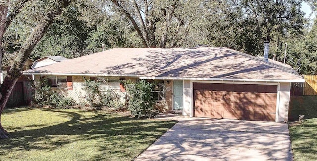 single story home featuring a garage and a front lawn