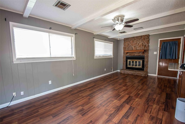 unfurnished living room featuring beamed ceiling, a fireplace, a textured ceiling, ornamental molding, and dark hardwood / wood-style floors