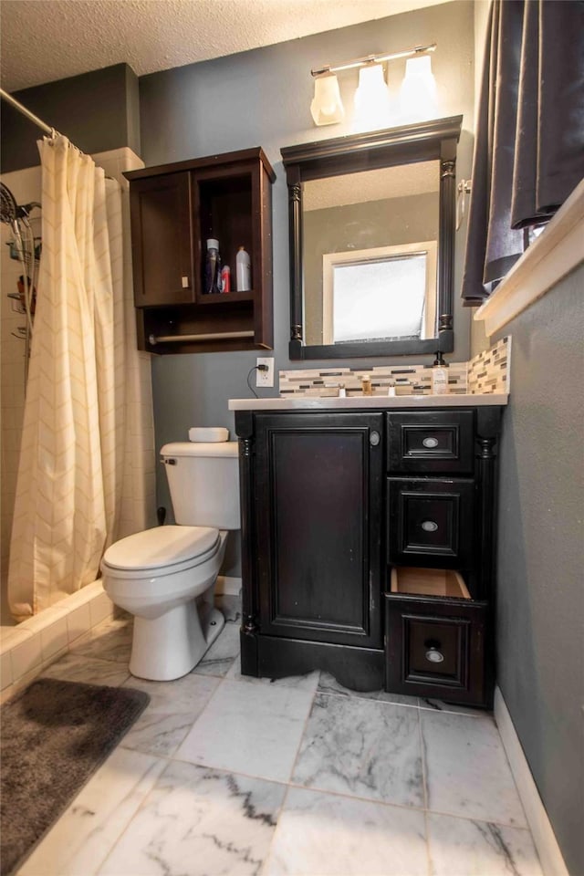 bathroom featuring vanity, toilet, walk in shower, and decorative backsplash