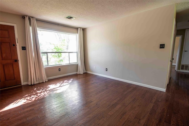 unfurnished bedroom featuring dark hardwood / wood-style floors and a textured ceiling