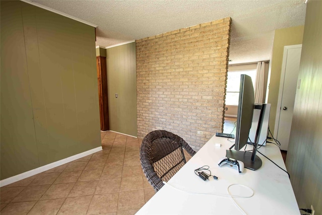 home office featuring light tile patterned flooring, a textured ceiling, brick wall, and wood walls