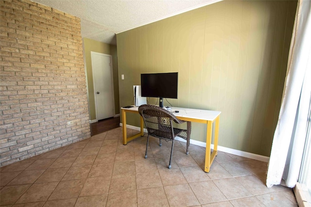 tiled home office featuring wood walls, ornamental molding, and a textured ceiling