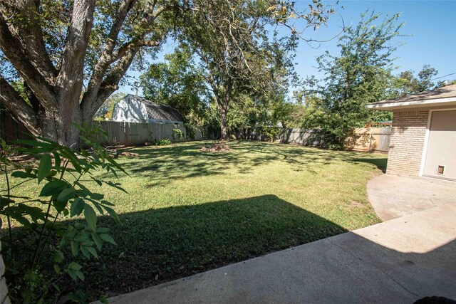 rear view of house featuring a lawn and a patio