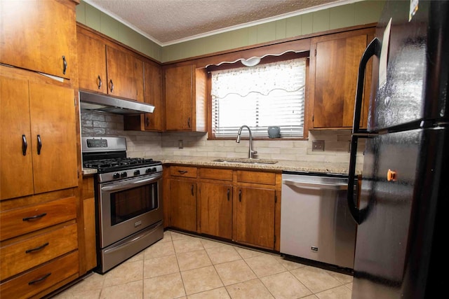 kitchen featuring dishwasher, sink, light tile patterned floors, a textured ceiling, and black fridge