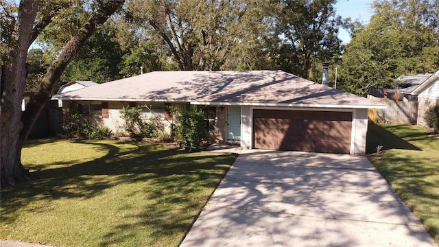 ranch-style home featuring a garage and a front lawn