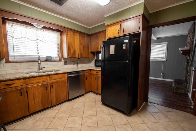 kitchen featuring black refrigerator, white dishwasher, a textured ceiling, sink, and stainless steel gas range oven