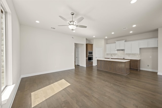 kitchen with open floor plan, appliances with stainless steel finishes, and dark wood finished floors