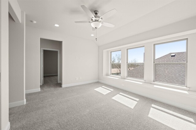 full bath featuring two vanities, tile patterned flooring, vaulted ceiling, a walk in closet, and a bath