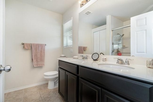 bathroom featuring tile patterned floors, vanity, and toilet