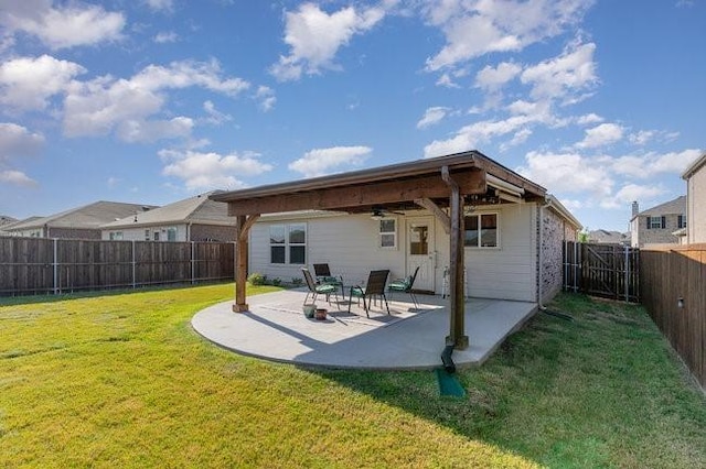 rear view of house featuring a yard, a patio, and ceiling fan