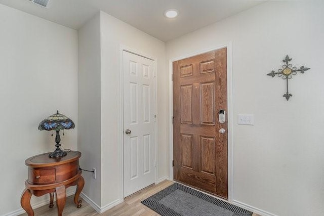 foyer entrance with light hardwood / wood-style flooring