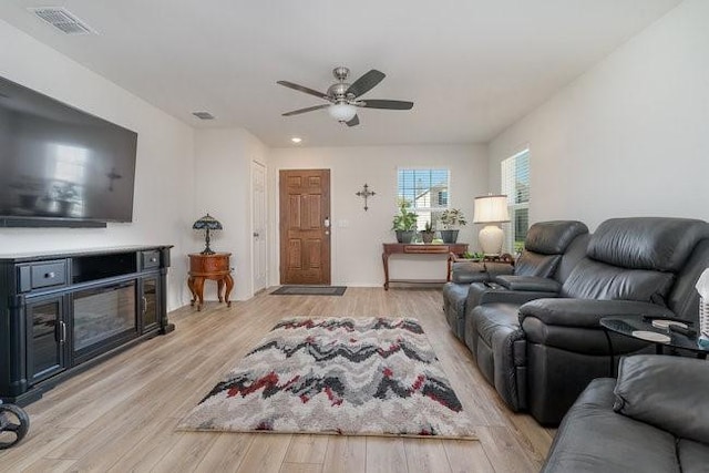 living room with ceiling fan and light hardwood / wood-style floors