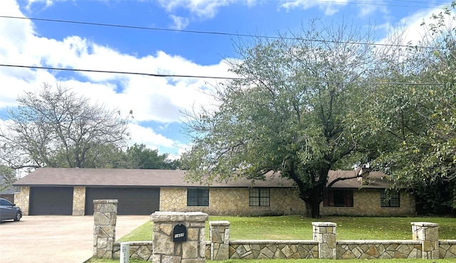 ranch-style home featuring a garage and a front lawn