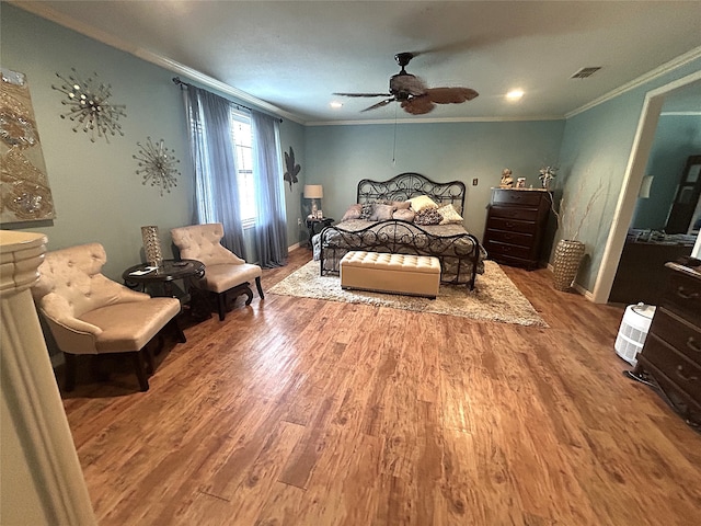 bedroom featuring crown molding, ceiling fan, and wood-type flooring