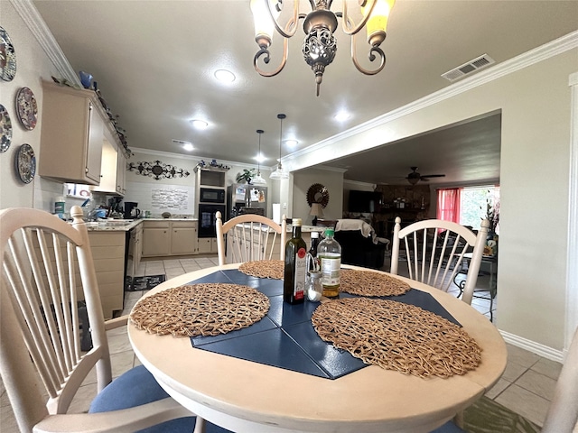 tiled dining room with ceiling fan with notable chandelier and ornamental molding