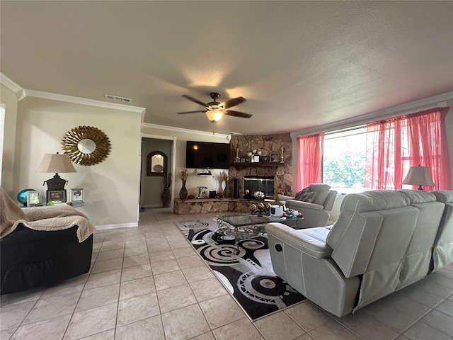 living room with a fireplace, light tile patterned floors, ceiling fan, and ornamental molding