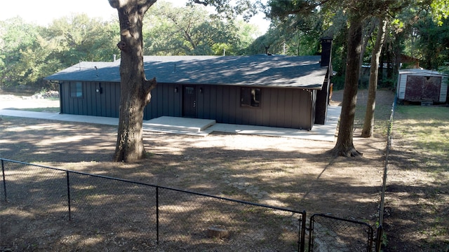 exterior space with a storage shed and a patio area