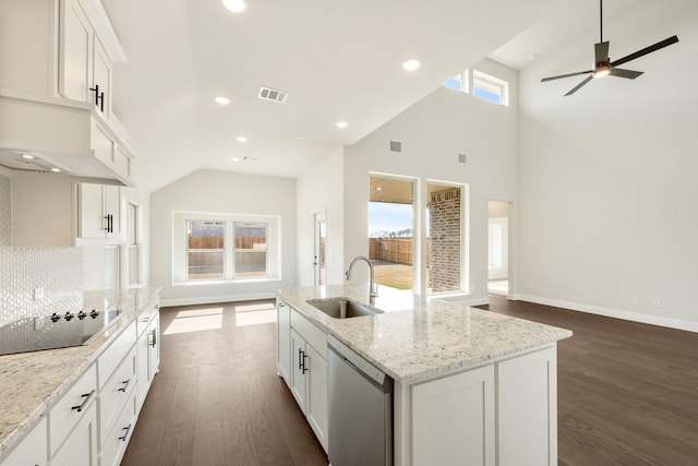 kitchen with white cabinets, dishwasher, sink, a kitchen island with sink, and black electric cooktop