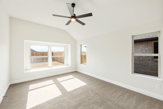 unfurnished room with carpet floors, vaulted ceiling, and ceiling fan