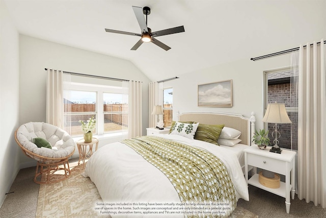 carpeted bedroom with ceiling fan and vaulted ceiling