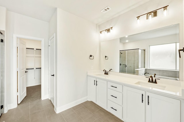 bathroom with vanity, tile patterned floors, and a shower with door