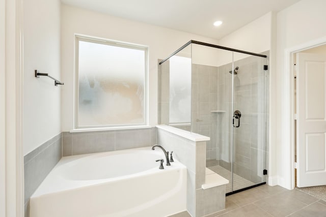 bathroom featuring tile patterned floors and shower with separate bathtub