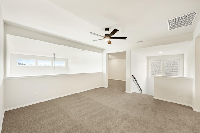 carpeted spare room with ceiling fan